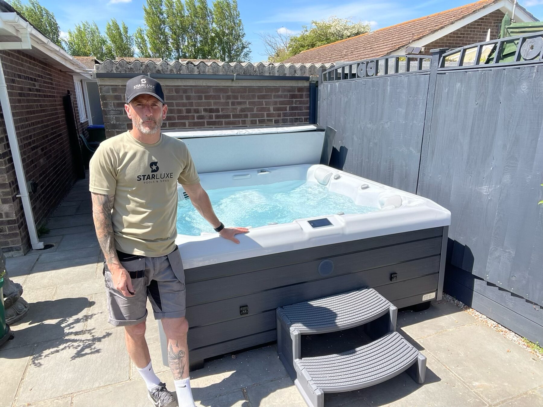StarLuxe engineer beside a newly serviced hot tub in a Sussex garden