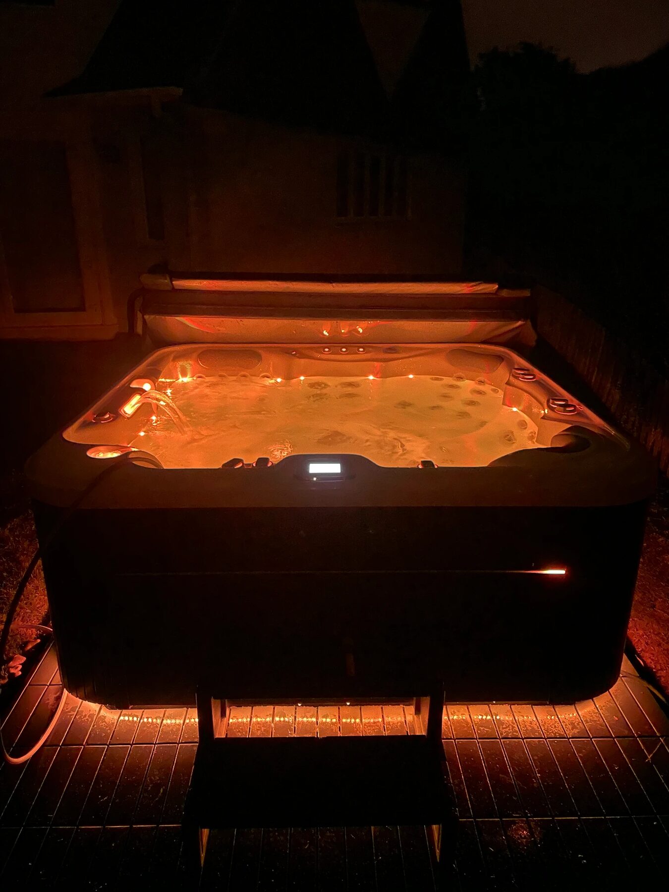 Hot tub with warm lighting at dusk